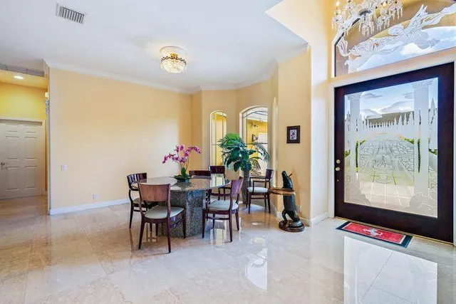 a view of a dining room with furniture and a potted plant