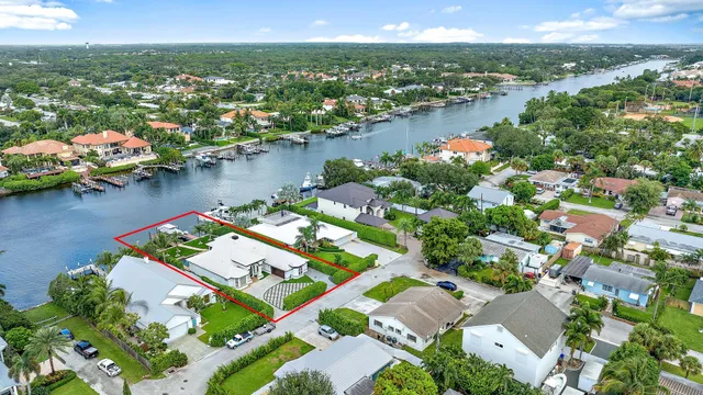 an aerial view of residential houses with outdoor space and lake view
