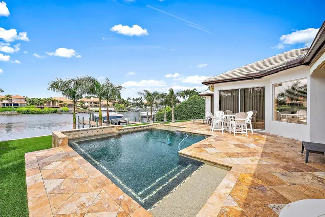 a view of swimming pool with outdoor seating and plants