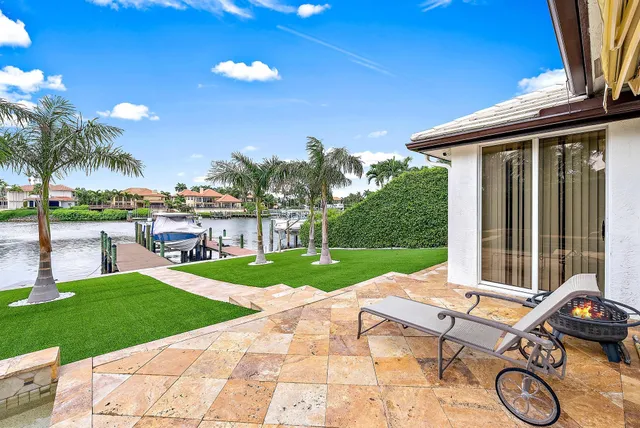 a view of a backyard with sitting area