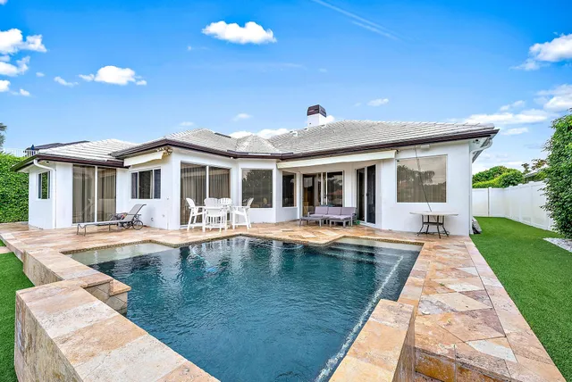 a view of a house with swimming pool and porch
