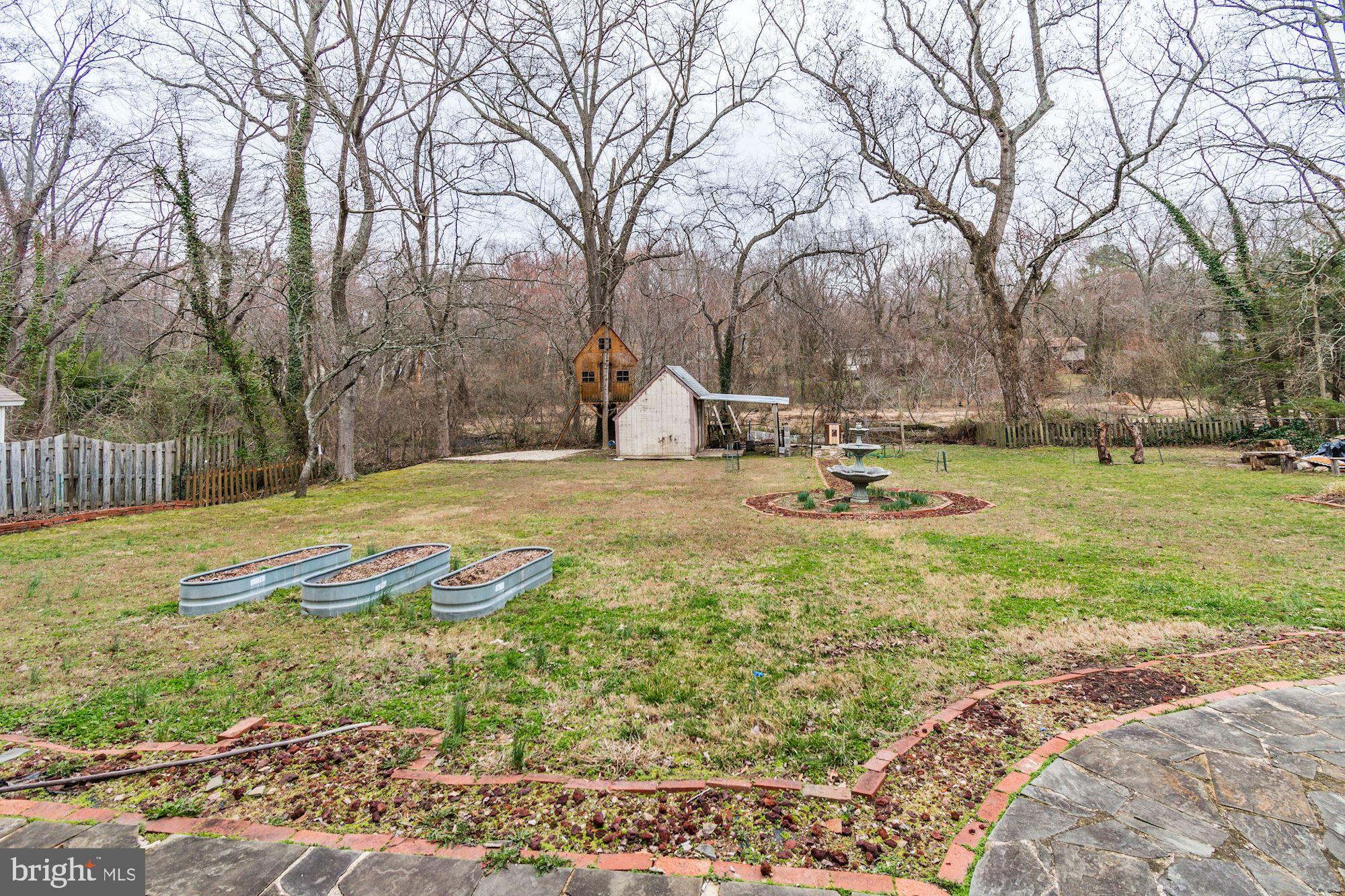 8721 Gateshead Road Alexandria, VA 22309 - Photo 45 of 48 Large backyard that backs to trees and a stream