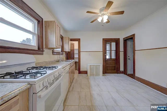 a kitchen with stainless steel appliances granite countertop a stove a refrigerator and a cabinets