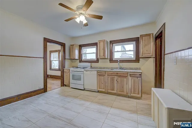 a kitchen with a cabinets window and stainless steel appliances