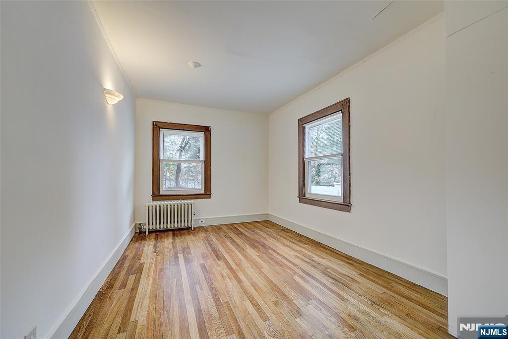 24 Brook Street Springfield, NJ 07081 - Photo 14 of 28 an empty room with wooden floor and windows