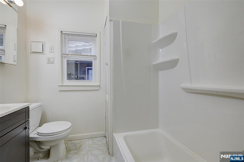 24 Brook Street Springfield, NJ 07081 - Photo 15 of 28 a bathroom with a toilet and a bathtub