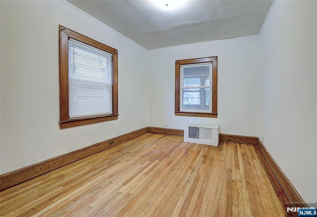 24 Brook Street Springfield, NJ 07081 - Photo 16 of 28 a view of an empty room with window and wooden floor