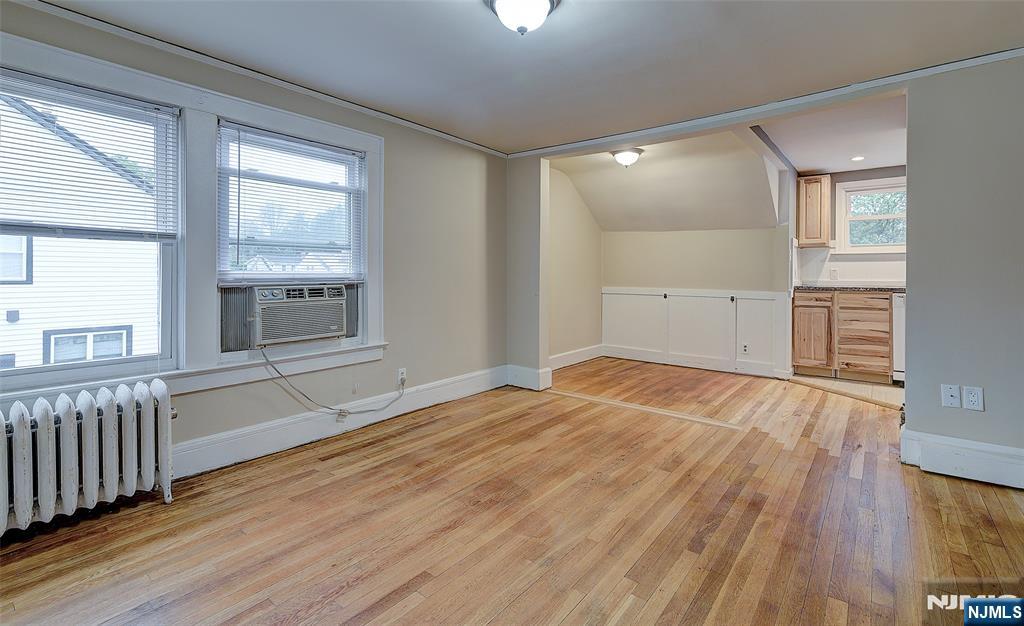 24 Brook Street Springfield, NJ 07081 - Photo 20 of 28 an empty room with wooden floor and windows