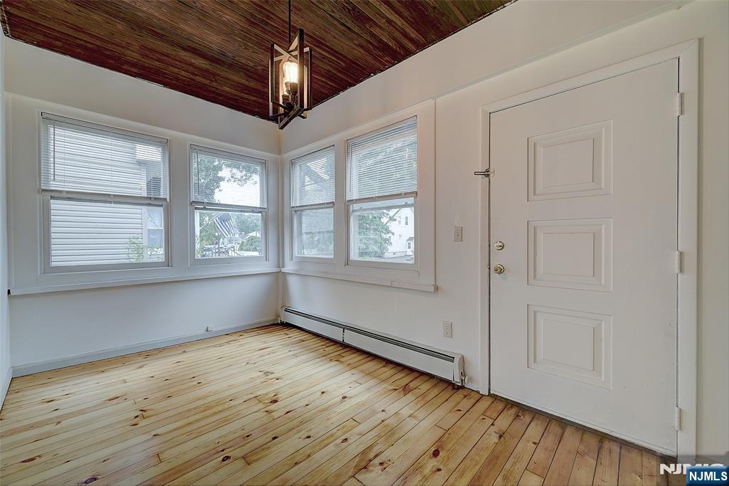 24 Brook Street Springfield, NJ 07081 - Photo 2 of 28 a view of empty room with wooden floor and fan
