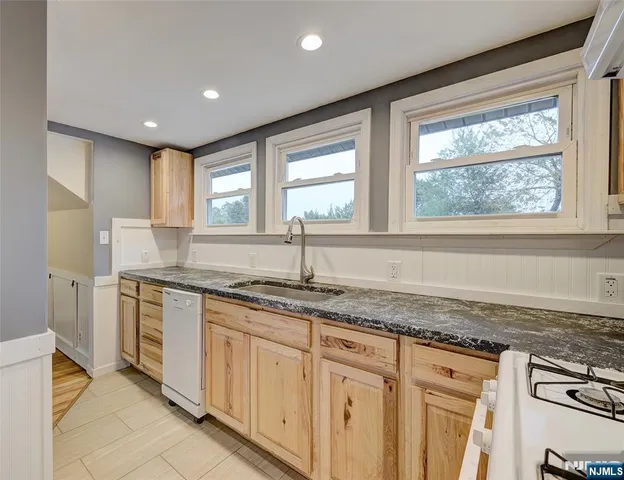 a kitchen with granite countertop a sink and a window