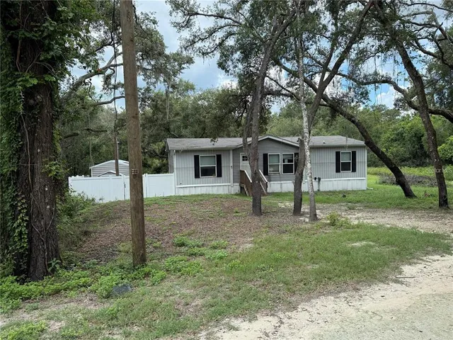 a house that has a tree in front of it