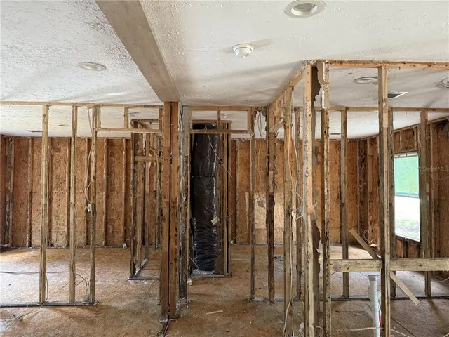 a view of a hallway with wooden walls