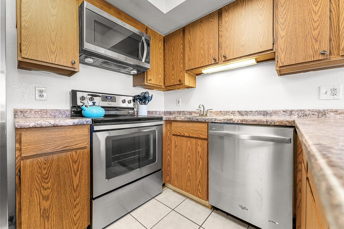 940 South Kihei Road, Unit B204 Kihei, HI 96753 - Photo 13 of 30 a kitchen with granite countertop cabinets stainless steel appliances and a sink