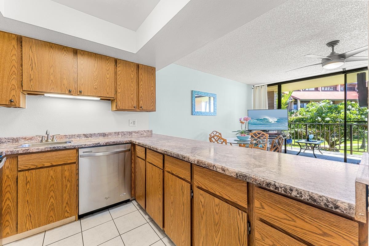 940 South Kihei Road, Unit B204 Kihei, HI 96753 - Photo 14 of 30 a kitchen with stainless steel appliances granite countertop sink stove and cabinets