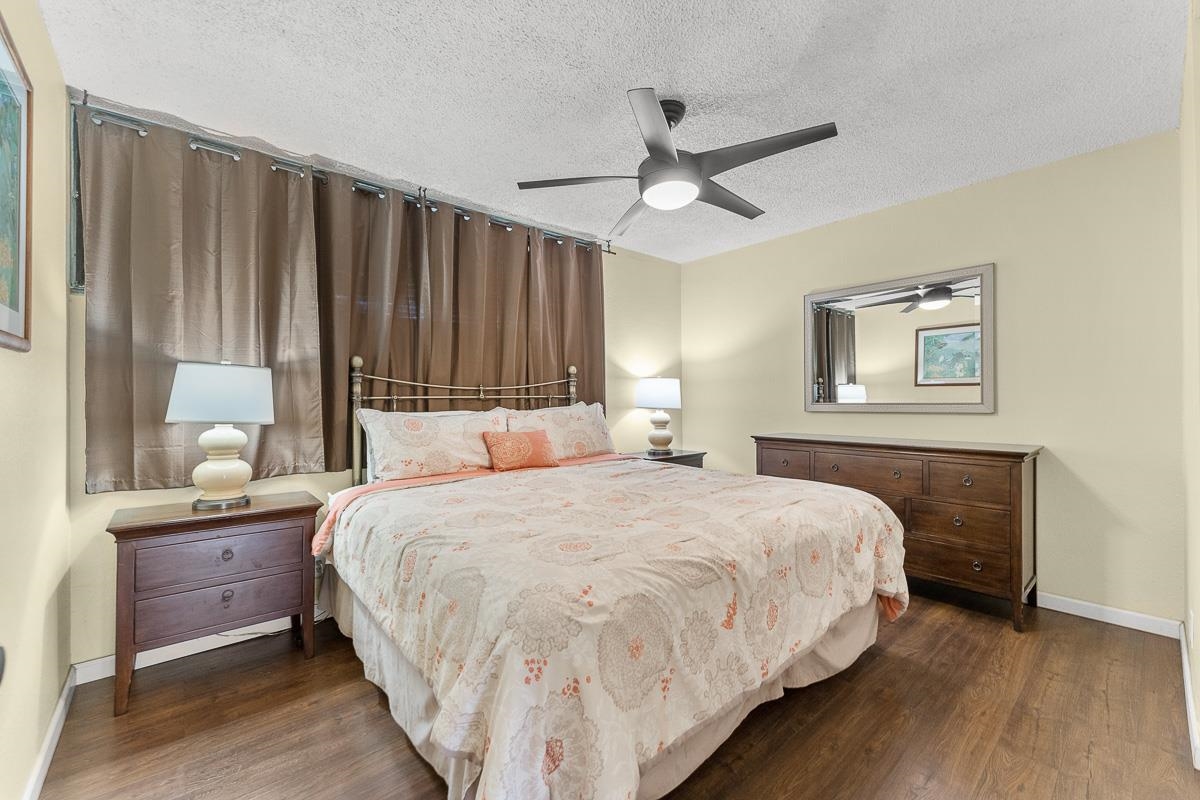 940 South Kihei Road, Unit B204 Kihei, HI 96753 - Photo 20 of 30 a bedroom with a bed and a chandelier
