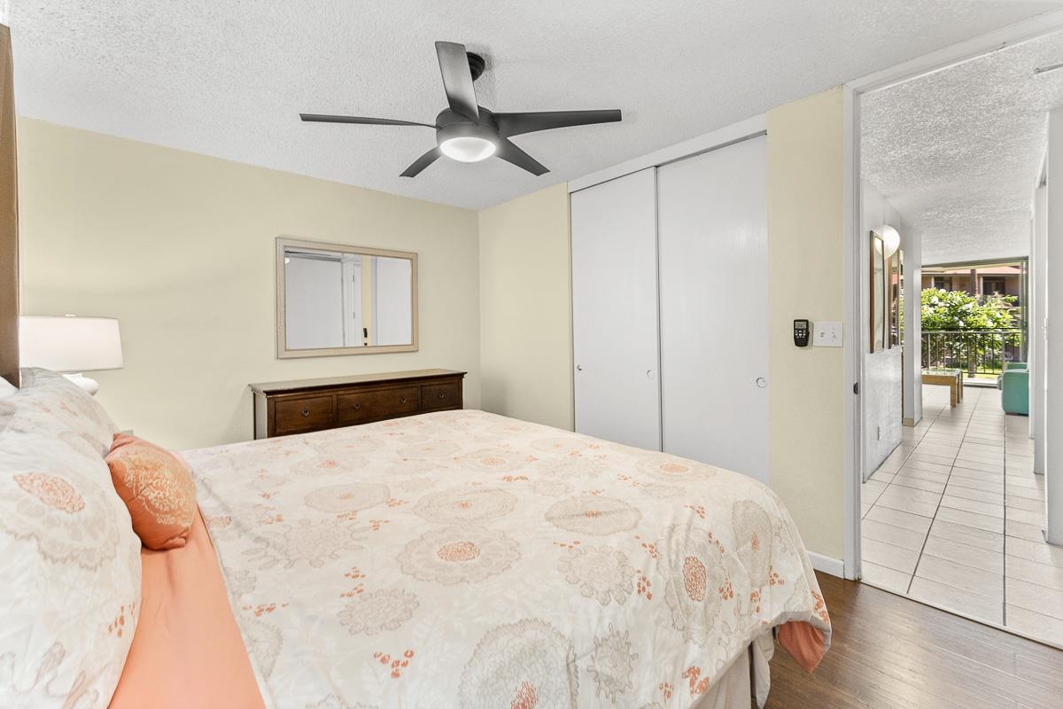 940 South Kihei Road, Unit B204 Kihei, HI 96753 - Photo 22 of 30 a bedroom with a bed and a chandelier