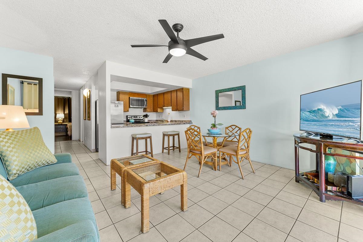 940 South Kihei Road, Unit B204 Kihei, HI 96753 - Photo 7 of 30 a living room with furniture a fireplace and a flat screen tv