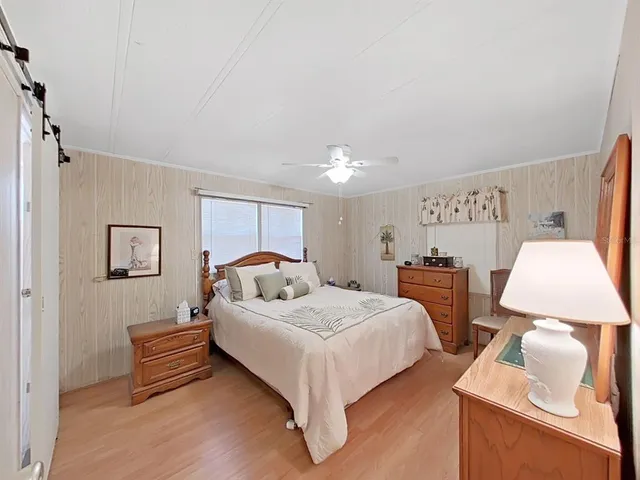 a bedroom with a bed and a lamp