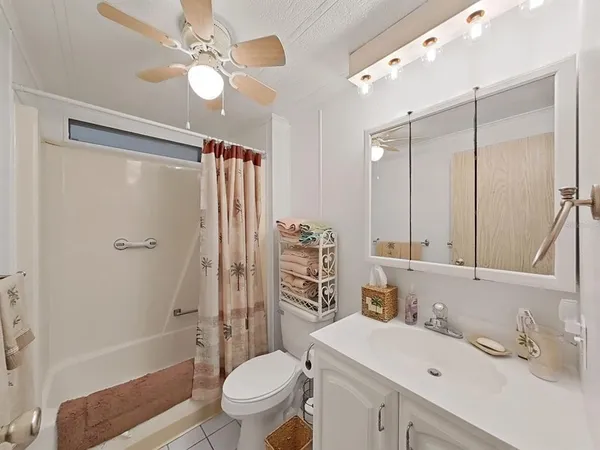 a bathroom with a sink toilet tub and shower