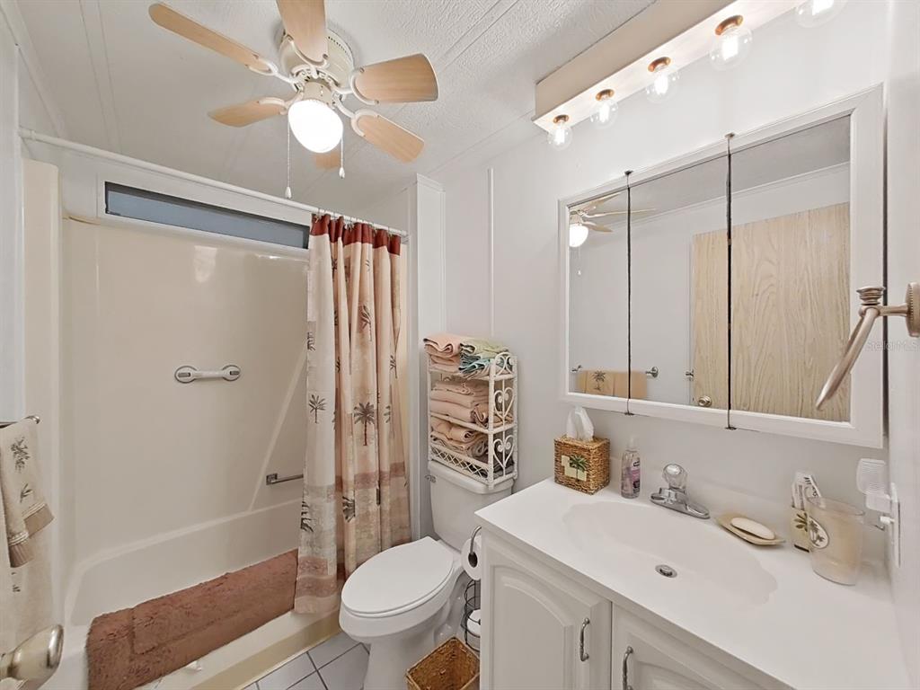 12501 Ulmerton Road, Unit 140 Largo, FL 33774 - Photo 14 of 20 a bathroom with a sink toilet tub and shower