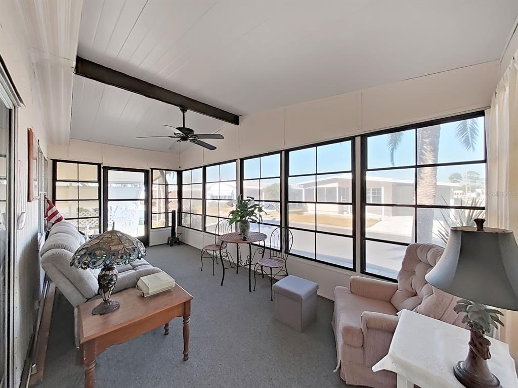 12501 Ulmerton Road, Unit 140 Largo, FL 33774 - Photo 16 of 20 a living room with furniture and floor to ceiling windows