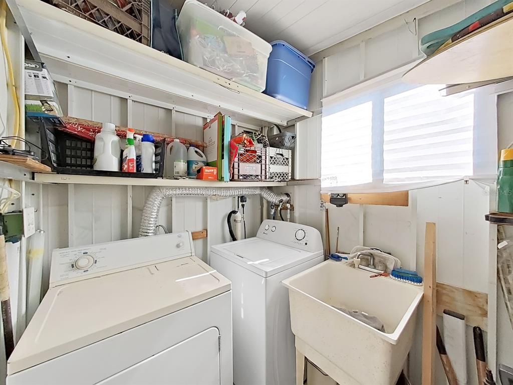 12501 Ulmerton Road, Unit 140 Largo, FL 33774 - Photo 17 of 20 a utility room with dryer washer and a window