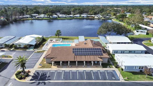 an aerial view of a house with garden space and lake view