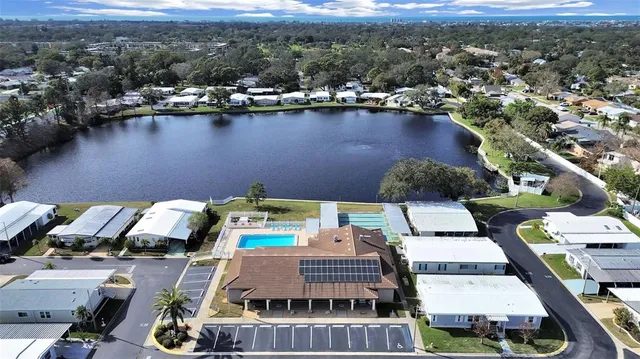 an aerial view of a house with a lake view