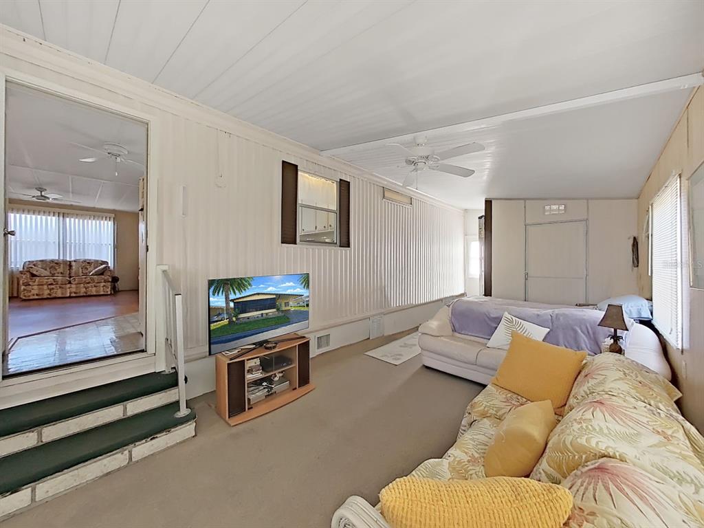 12501 Ulmerton Road, Unit 140 Largo, FL 33774 - Photo 3 of 20 a living room with furniture and a flat screen tv