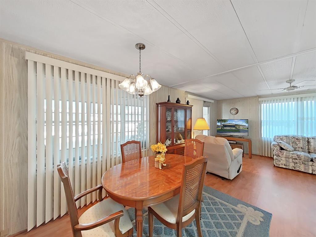 12501 Ulmerton Road, Unit 140 Largo, FL 33774 - Photo 4 of 20 a view of a dining room with furniture window and wooden floor