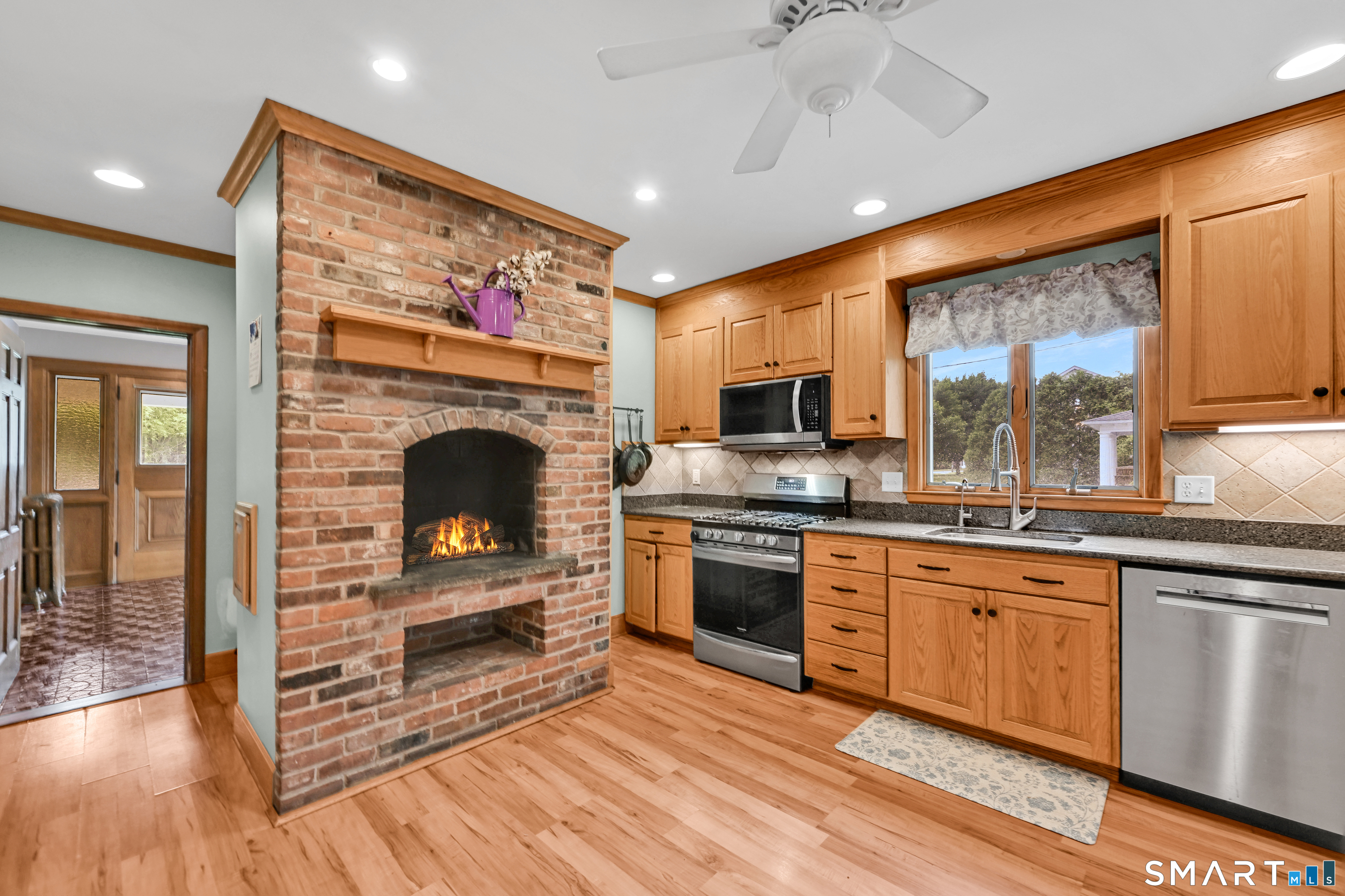 295 Wolcott Hill Road Wethersfield, CT 06109 - Photo 10 of 40 Kitchen features a fireplace in the kitchen