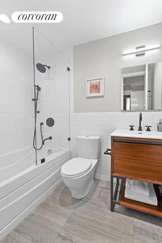 a bathroom with a toilet a sink and mirror