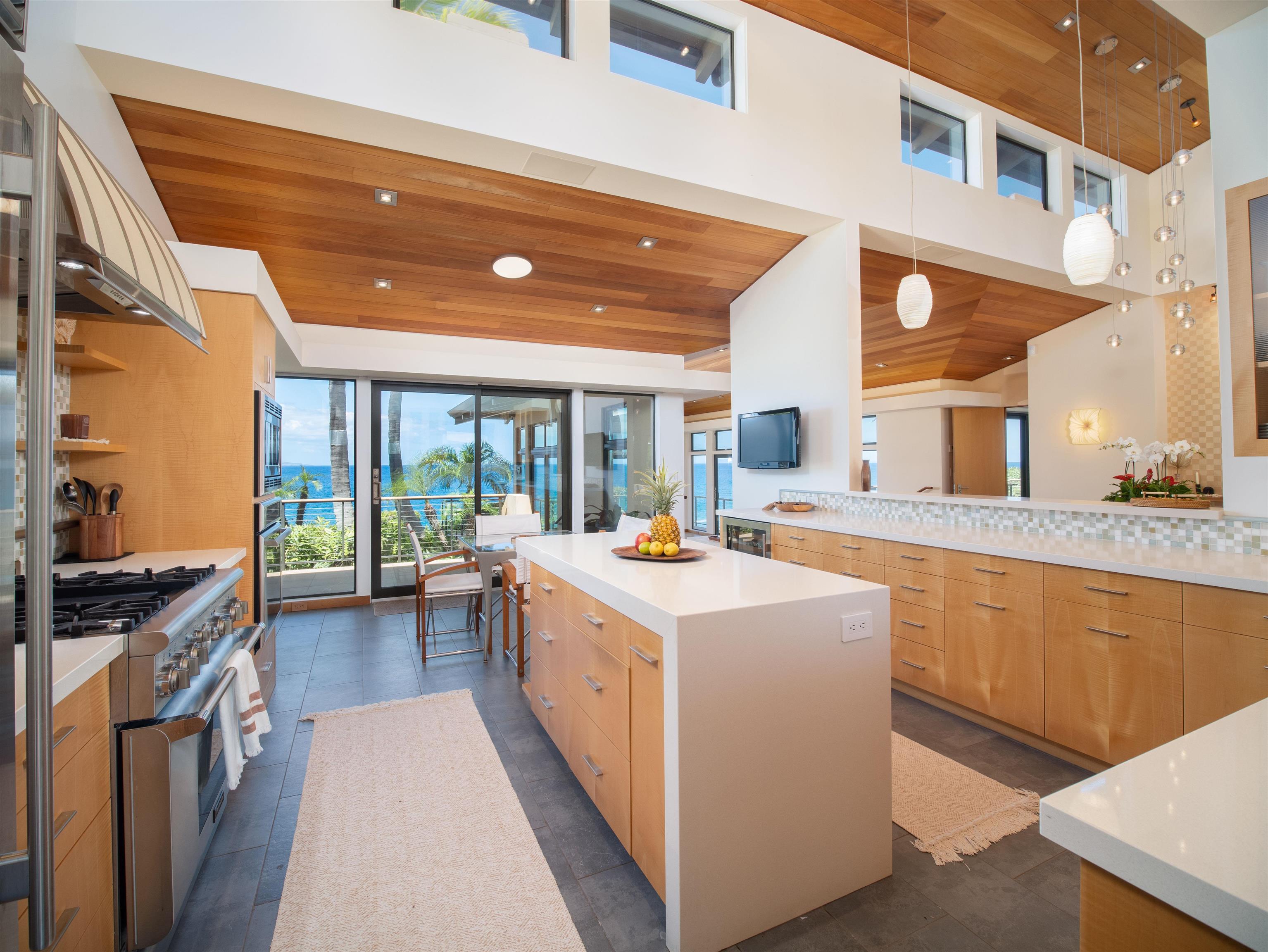 4640-4650 Makena Road Kihei, HI 96753 - Photo 19 of 48 a kitchen with stainless steel appliances granite countertop a stove and a large window