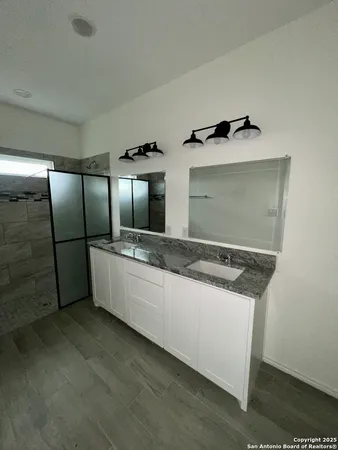 a large white kitchen with a sink and refrigerator