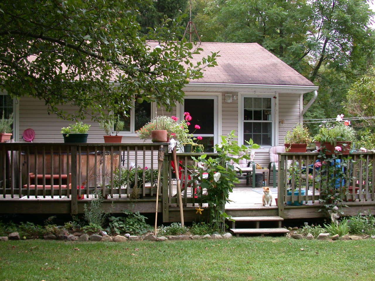 a front view of a house with garden and outdoor seating