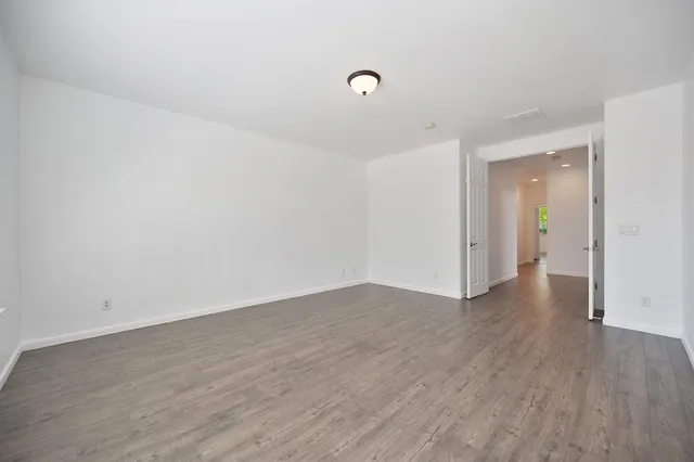 a bathroom with a double vanity sink large mirror and a bathtub