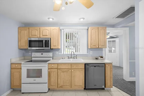 a kitchen with a stove sink and microwave