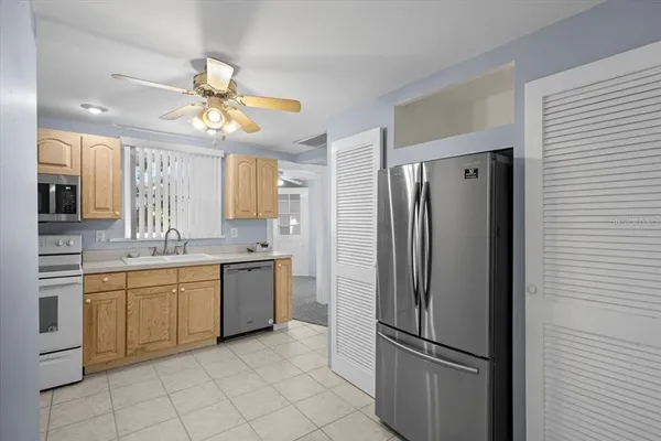 a kitchen with a refrigerator a sink and dishwasher