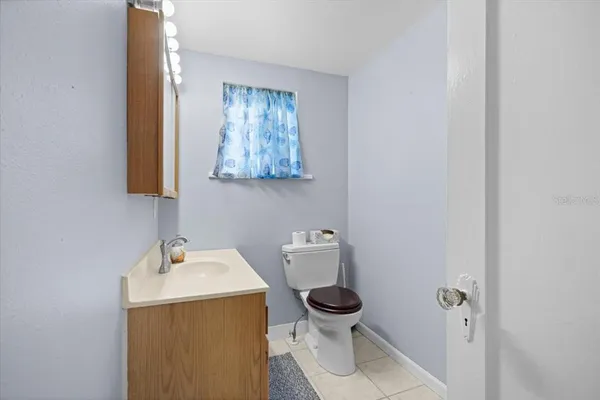 a bathroom with a sink and mirror with toilet