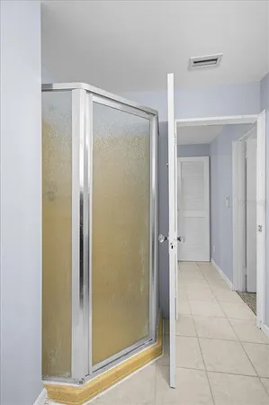a bathroom with a shower and a glass door