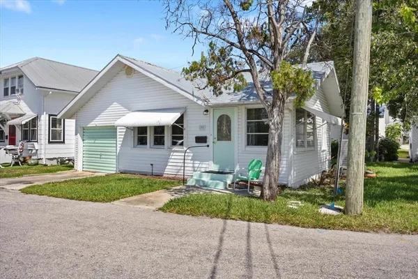 a front view of a house with a yard and porch