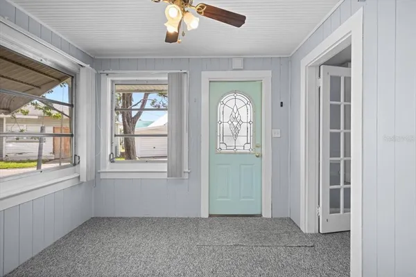 an empty room with windows and closet