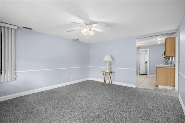 a view of a livingroom with a furniture and a ceiling fan