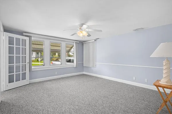 a view of livingroom with furniture chandelier and window