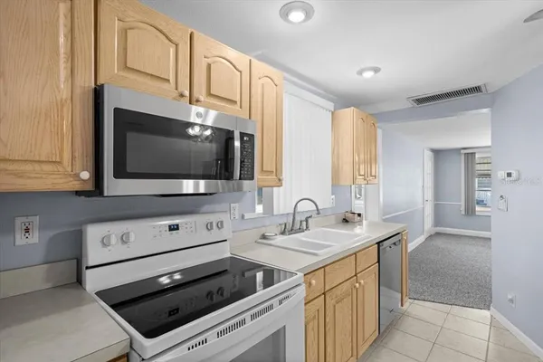 a kitchen with stainless steel appliances a stove microwave and cabinets