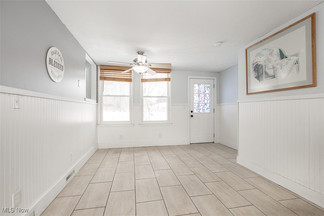 15446 Drake Road Strongsville, OH 44136 - Photo 5 of 42 Entryway featuring a ceiling fan and wainscoting