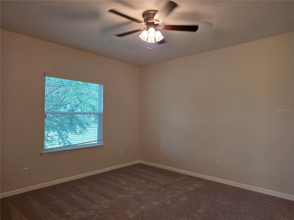 1571 Danisco Place Apopka, FL 32703 - Photo 13 of 26 an empty room with a window and a fan