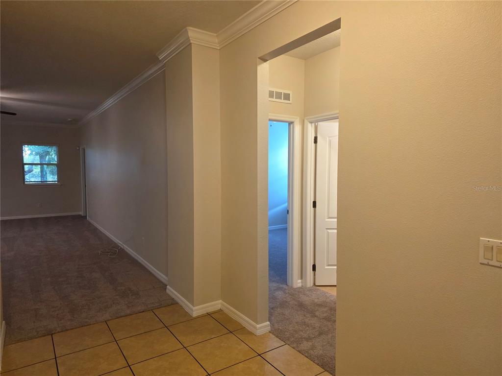 1571 Danisco Place Apopka, FL 32703 - Photo 17 of 26 a view of a hallway with wooden floor