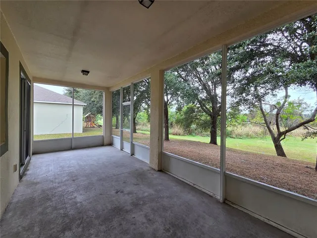 a view of a room with a large tree and wooden fence