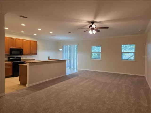 a view of kitchen with refrigerator and microwave